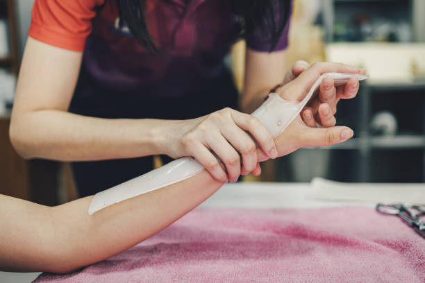 terapeuta fazendo dispositivo assistente para imobilizar a mão do paciente. serviço de tala para reabilitação de lesão na mão da clínica de terapia ocupacional. - tala - fotografias e filmes do acervo