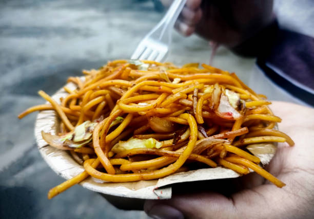istock Asian man eating noodle. man hands holding fork and spoon during eating noodle 1433613333
