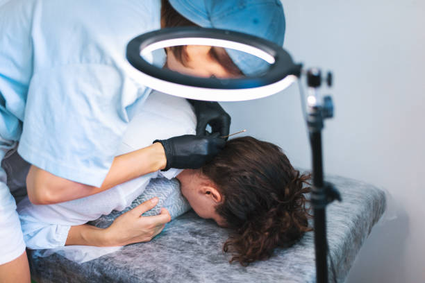 istock Tattoo master tattooing woman's neck 1433613362