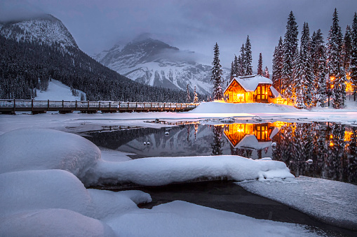 A cozy wooden house by Emeral Lake in the winter.