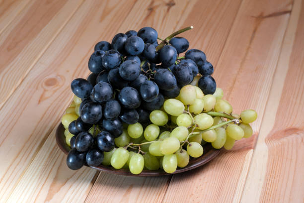 istock Sweet ripe white and black unwashed grapes 1433615126