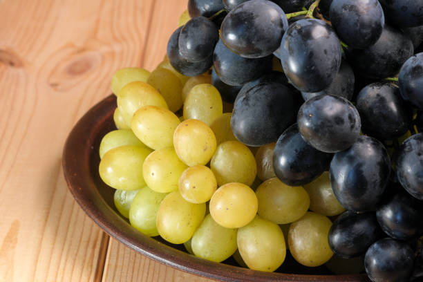 istock Sweet ripe white and black unwashed grapes 1433615160