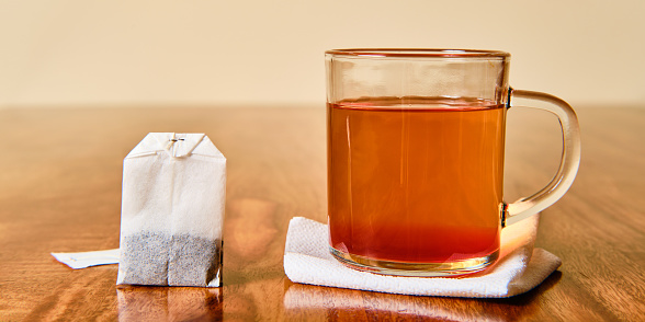 Hot fruit tea in glass and teabag