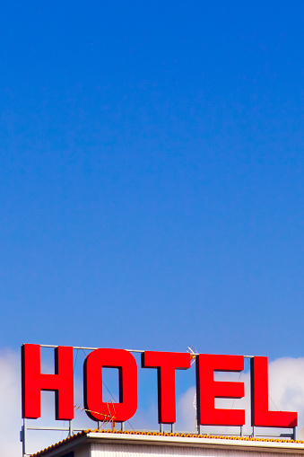 Large hotel sign on top of building rooftop , clear sky in the background. Rías Baixas, Galicia, Spain.