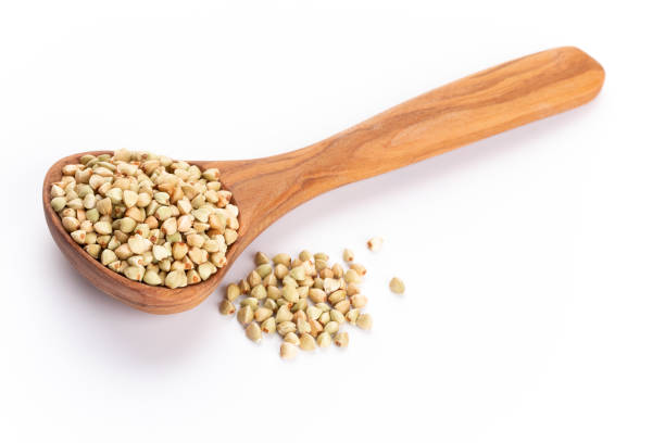 istock Raw buckwheat and wooden spoon on white background. 1433622493