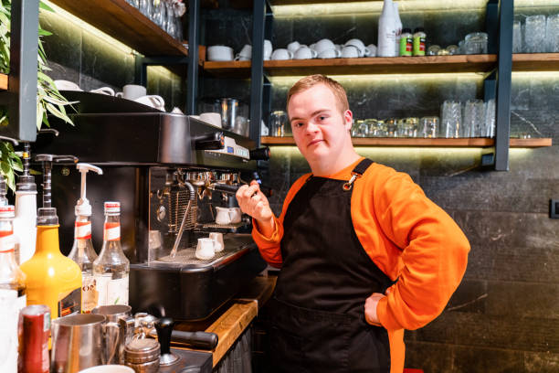istock Young man with Down Syndrome working at cafe, preparing coffee 1433622754