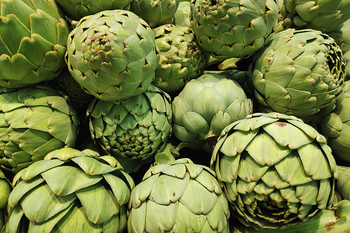 Fresh artichokes on the white wooden table
