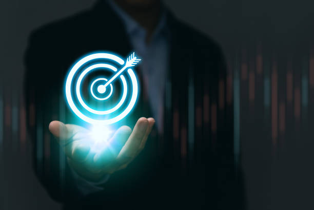 istock Businessman showing virtual digital technology darts icon arrows on the board. objective concept and goals for business investment Marketing Strategy and Aims for Success 1433630999