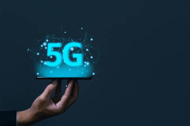 istock businessman holding a smartphone with hologram 5G digital technology, access to information around the world. 5G wireless internet network concept or IOT, high-speed communication connection. 1433631002