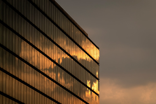 corporate buildings with clouds in financial district of hong kong day.modern glass window in the sunshine at sunset.
