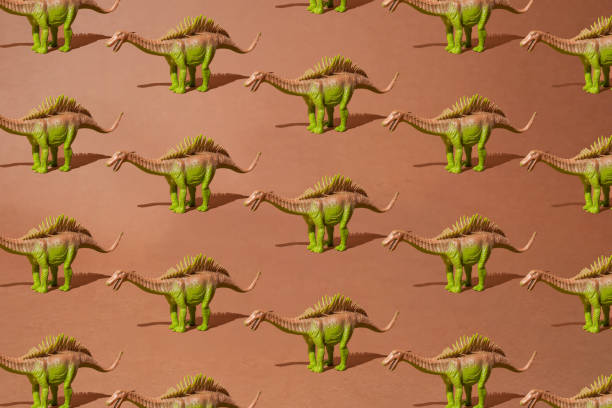 istock Brown green spiny dinosaur on a dirty brown background. Pattern. Minimal design. 1433633274