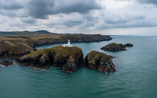 aerial landscape view of the Pembrokeshire coast with the historic Strumble Head Lighthouse