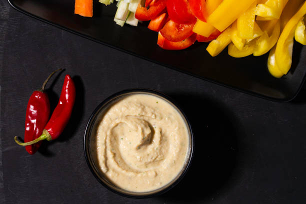 istock Hummus with vegetables on black plate 1433636462