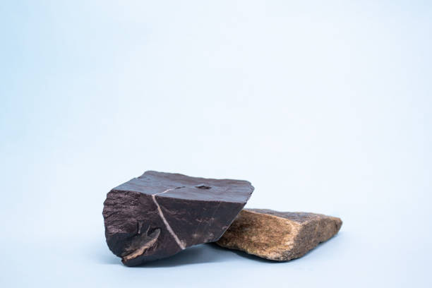 istock Black and brown natural stones podium on light blue background, platform for product display. Blank for mockup design 1433639010