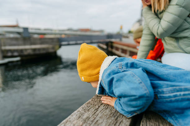 istock Little boy looking over the bridge rail 1433640533
