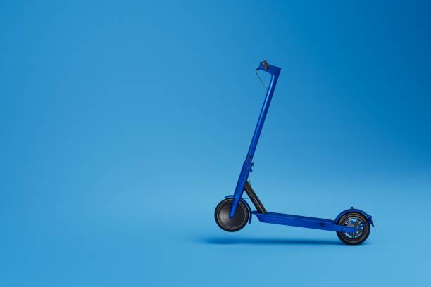 istock moving on an electric scooter. blue electric scooter on a blue background. copy paste, copy space. 3D render 1433641921