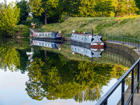 Canal Boat passing through a Lock with Lock Keepers house.
