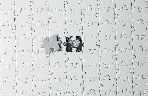 white puzzle pieces isolated on dark wooden table