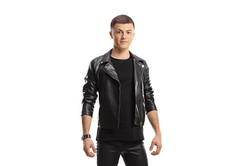 Young male in leather jacket and pants posing isolated on white background