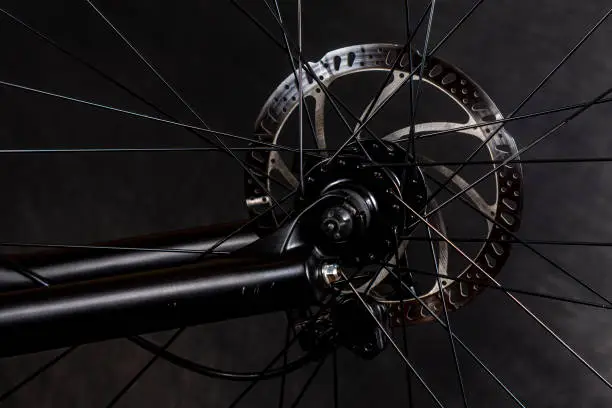 Close-up shot of a generic mountain bike disc brake rotor that is mounted on a bicycle.