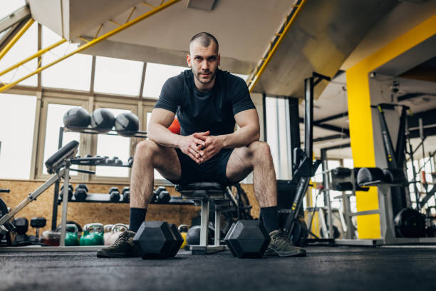 istock Strong man sitting in gym 1433654928