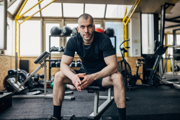 istock Strong man sitting in gym 1433654940