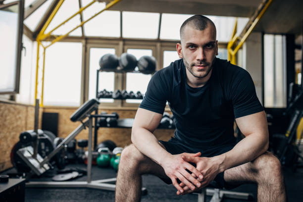 istock Strong man sitting in gym 1433655038