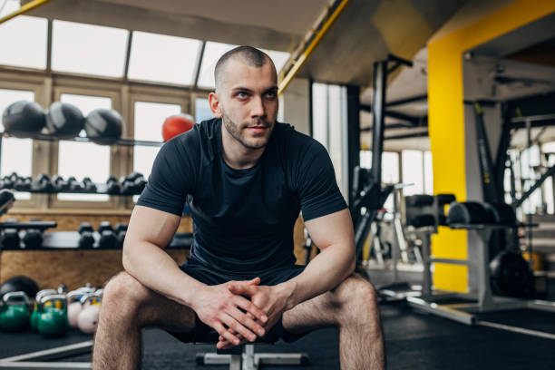 istock Strong man sitting in gym 1433655061