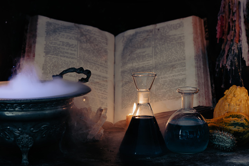 Spell book, magic potions and smoking cauldron