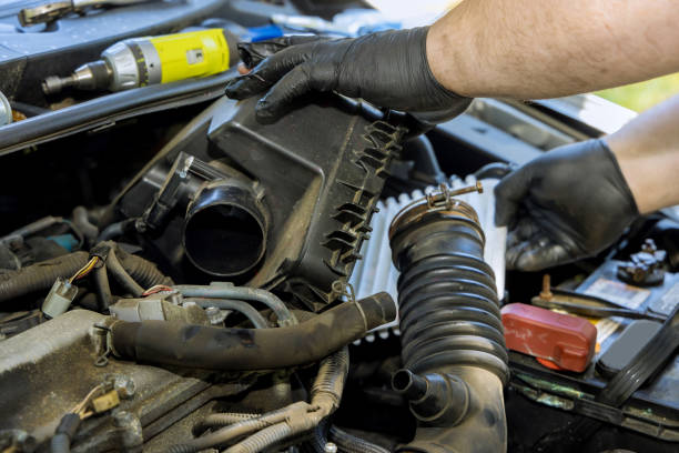 istock An automobile mechanics hand is holding a replacement car air filter as it is installed into the engine of a vehicle at a service center. 1433656567