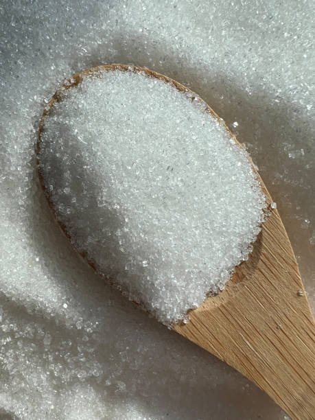 istock Sugar in a wooden spoon close-up. 1433657630