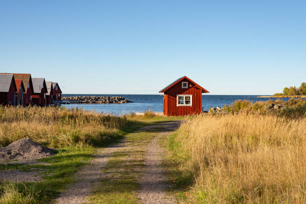 スウェーデンの海岸にある小さな赤いコテージ - red cottage small house ストックフォトと画像