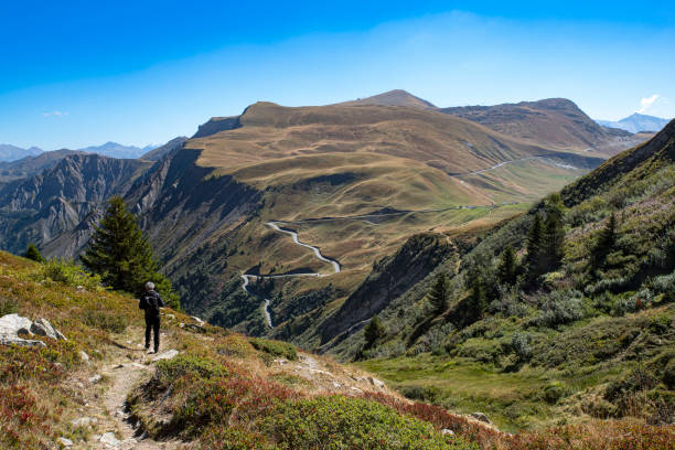 Mountain landscape in summer in the Alps in France with a hiker on a path