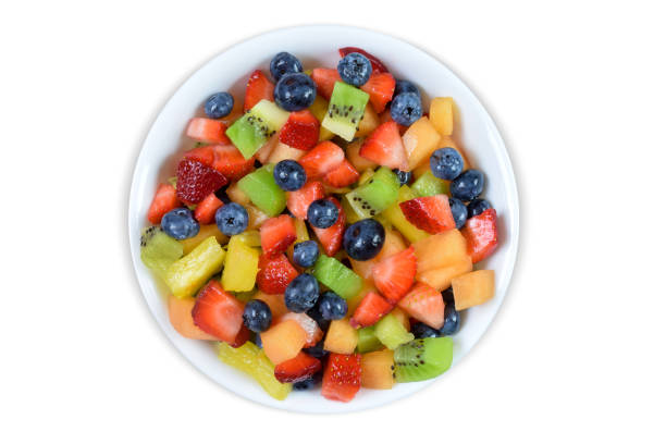 Top view of a colorful fresh cut fruit salad isolated on a white background with a clipping path.