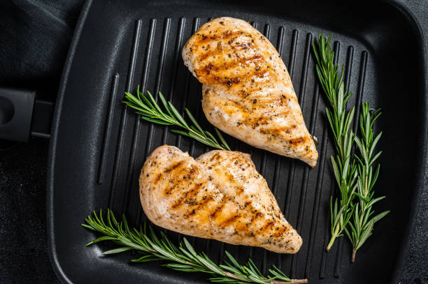 istock Grilled healthy chicken breasts cooked on a grill pan. Black background. Top view 1433668208