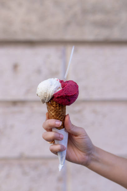istock Holding strawberry and vanilla ice cream with cone 1433672761