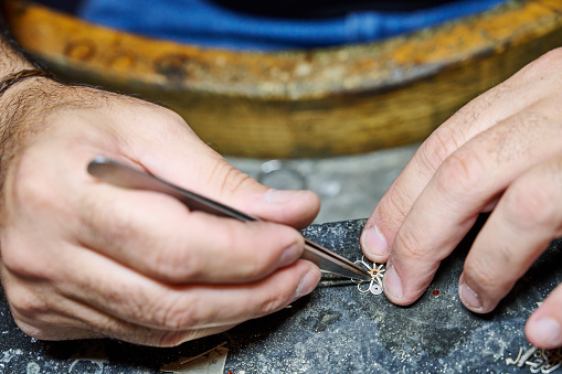 A goldsmith making a traditional Sardinia jewel in his workshop. Dorgali. Province of Nuoro. Italy.