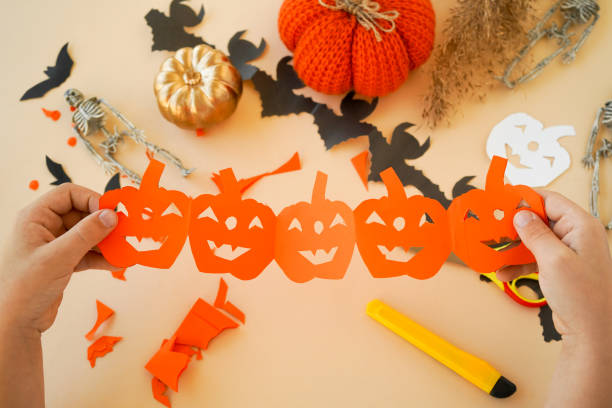 istock Step-by-step instructions for creating garlands of paper decorations by children for the Halloween holiday. Step 6 the garland is ready 1433673797