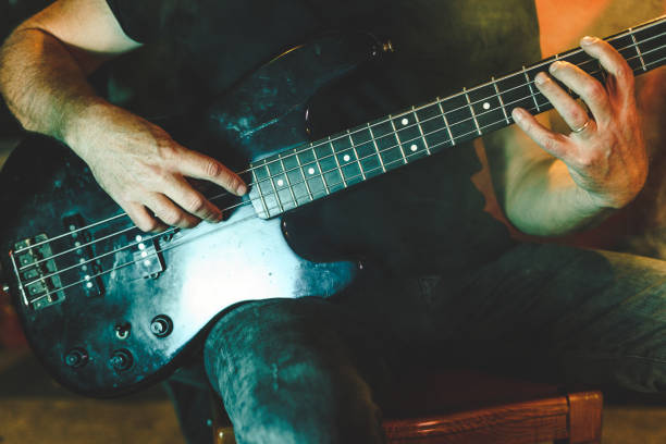 istock playing an electric bass 1433675482