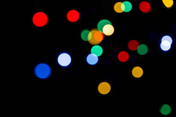 istock Clorful blurred lighs bokeh on black background as a festive backdrop 1433677066