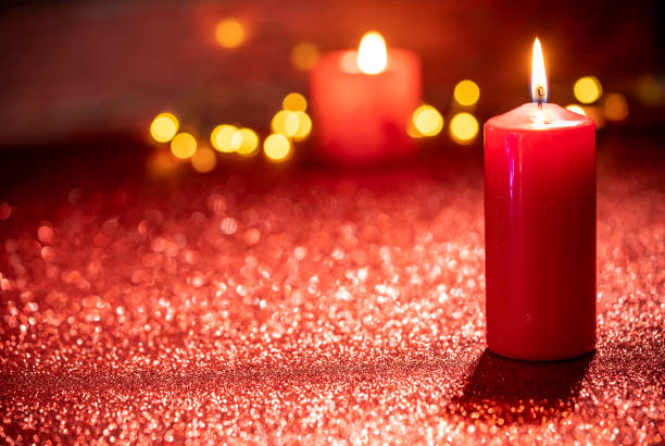 Red candle light Christmas candlelight on glowing flame sparklin
