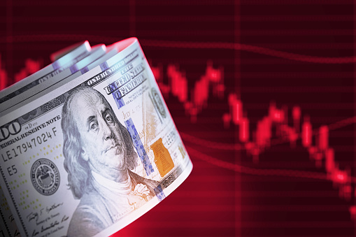 Finance Concept - 100 American Dollar Bills Over Red Bar Graph