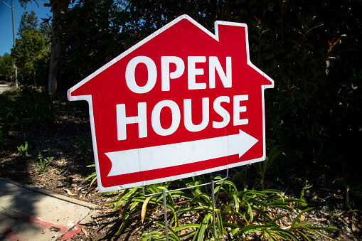 Red open house sign in the shape of a house