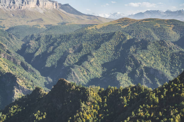 istock Mountain cliffs with a forest of deciduous trees and mountain ranges in the bright sun, warm autumn day in the Caucasus 1433681546