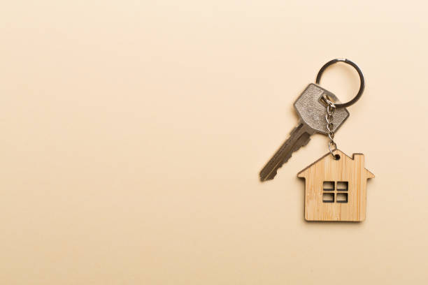 istock Keys with house-shaped keychain on color background 1433682584