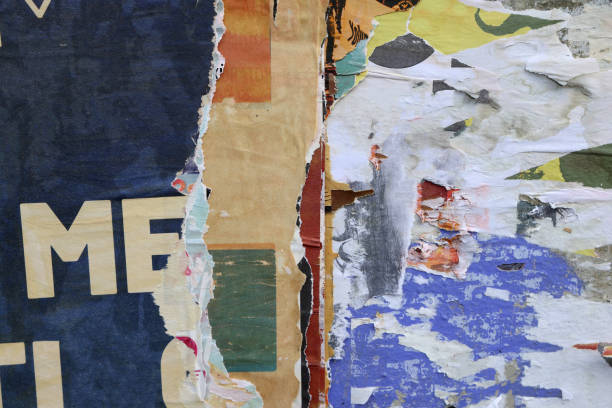 istock Pieces of torn paper peeling off wall used as billboard 1433683292