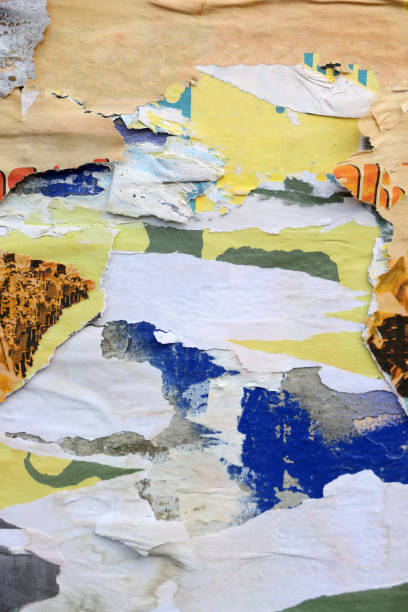 istock Pieces of torn paper peeling off wall used as billboard 1433683307