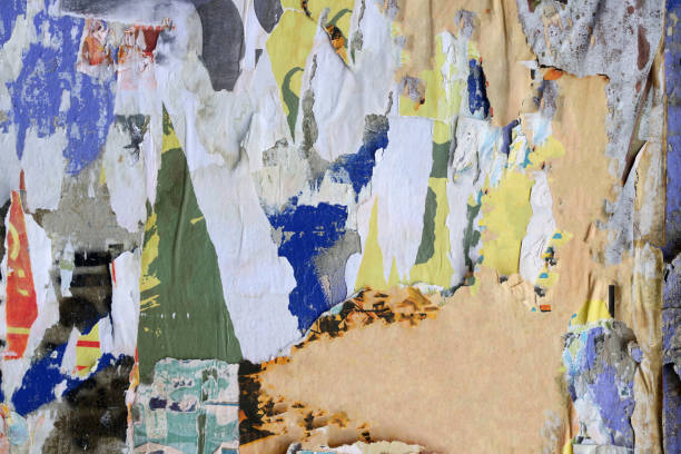 istock Pieces of torn paper peeling off wall used as billboard 1433683354
