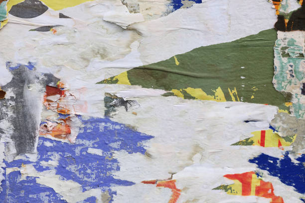 istock Pieces of torn paper peeling off wall used as billboard 1433683427