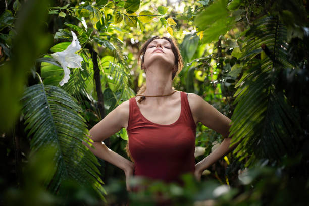 Inhaling fresh air Woman breathing fresh air in the tropical jungle mantra stock pictures, royalty-free photos & images